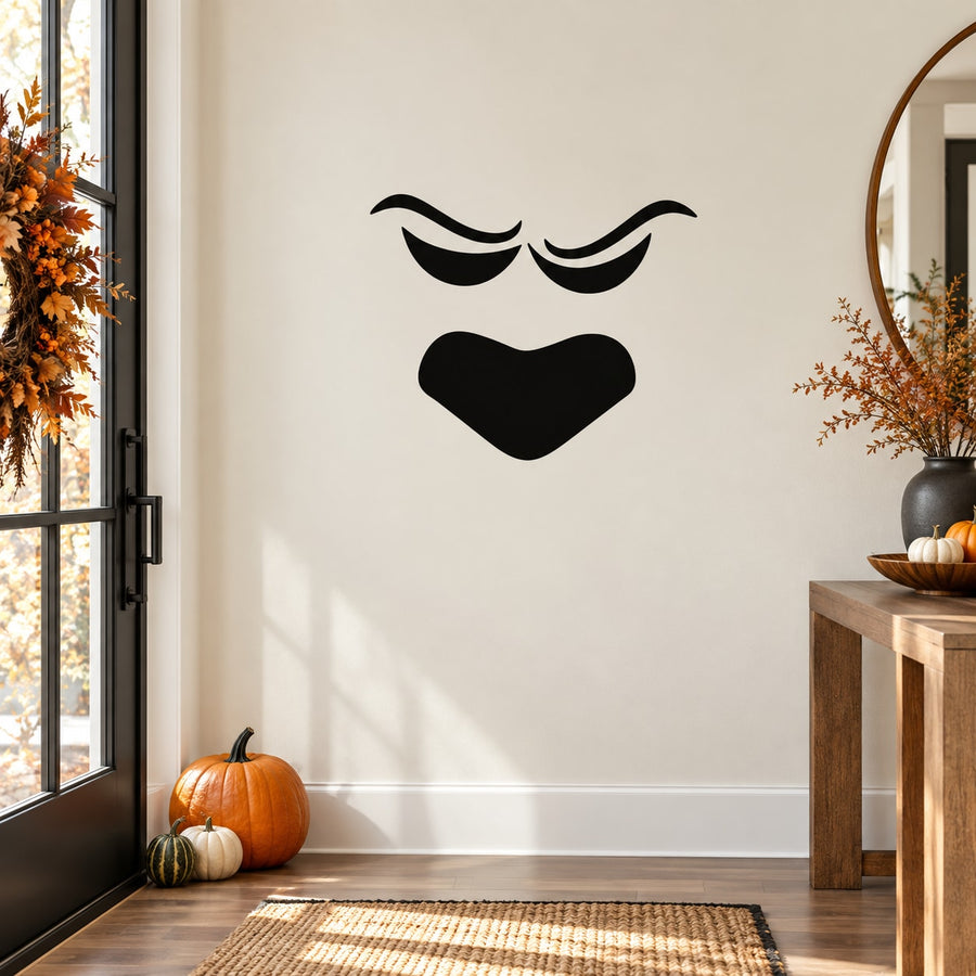 Black pumpkin face decal with closed eyes and open heart-shaped mouth