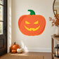Grinning Jack-o-Lantern sticker: orange pumpkin with yellow grin and green stem