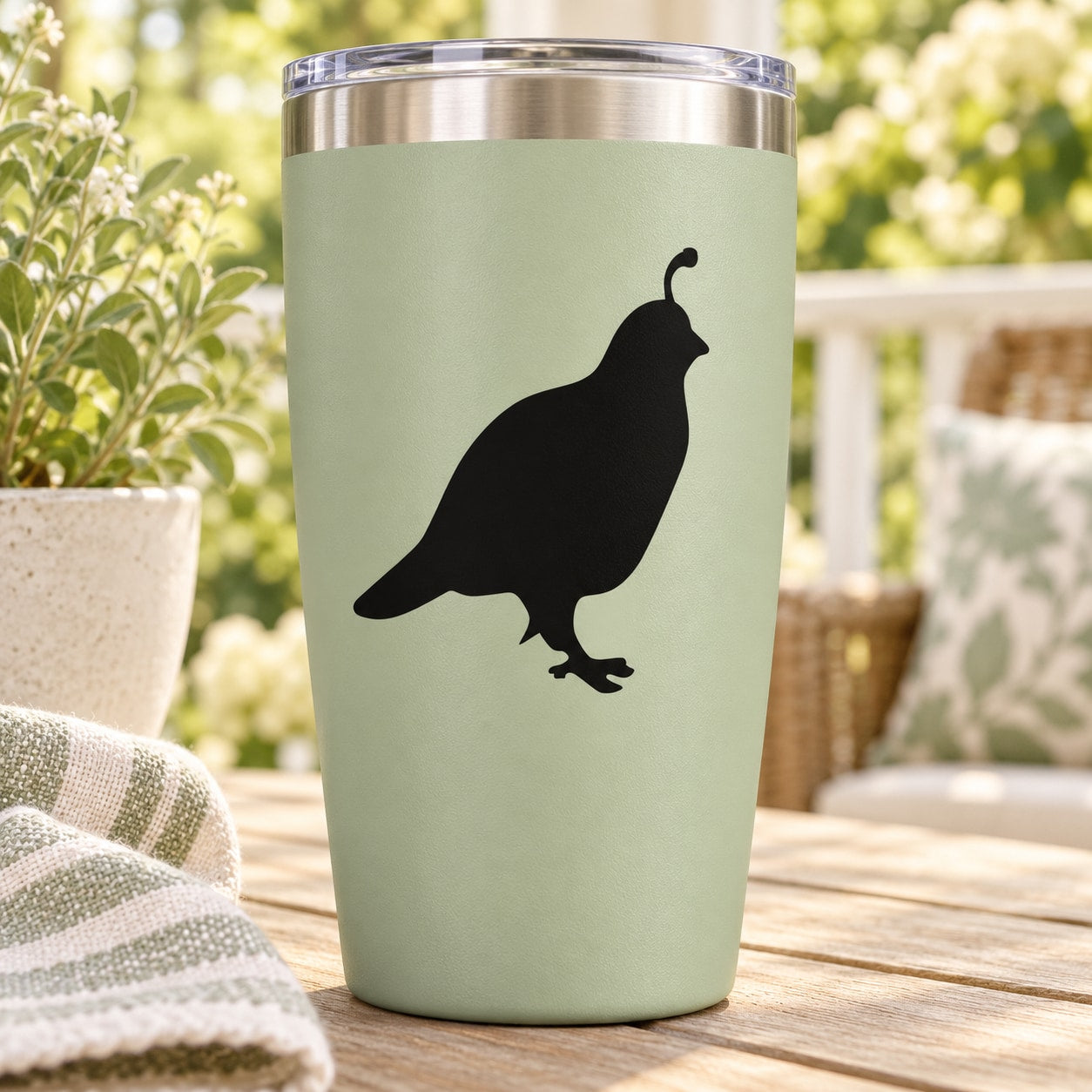 Stainless tumbler with black quail decal on pale green body