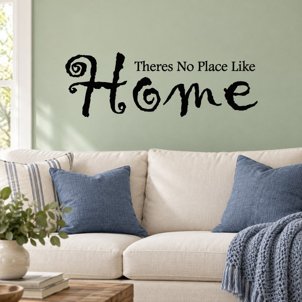 Black wall decal reading 'There's No Place Like Home' with decorative heart.