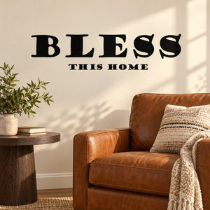 Wall mural decal with bold black “BLESS” text and “This home” subtitle