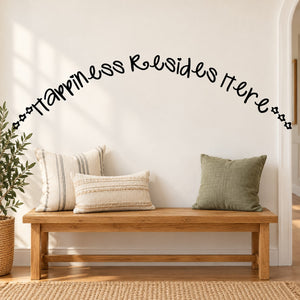 Wall decal with "happiness resides here" in black cursive lettering