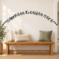 Wall decal with "happiness resides here" in black cursive lettering