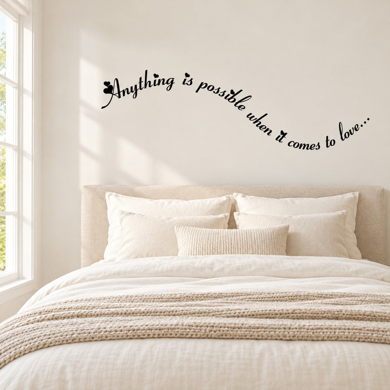 Cursive wall decal with black text, 'Anything is possible when it comes to love'
