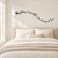 Cursive wall decal with black text, 'Anything is possible when it comes to love'