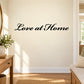 Wall decal with "Love at Home" in black script lettering