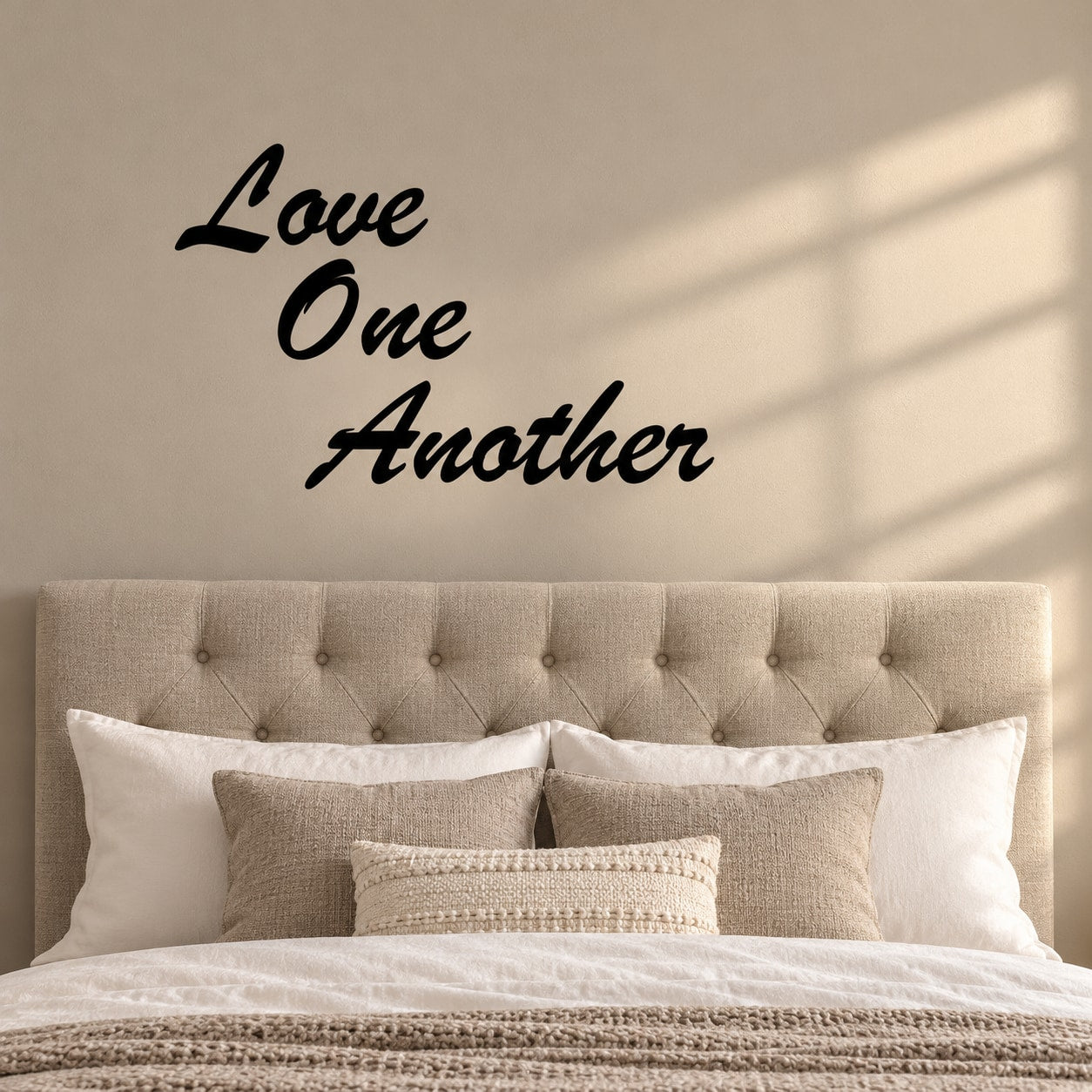 Stacked wall decal reading “Love One Another” in black script