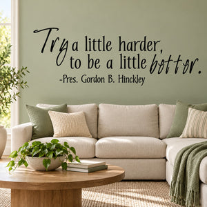 Wall decal with cursive quote: "Try a little harder, to be a little better".