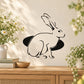 Rabbit and hole wall decal with black outline of a sitting rabbit