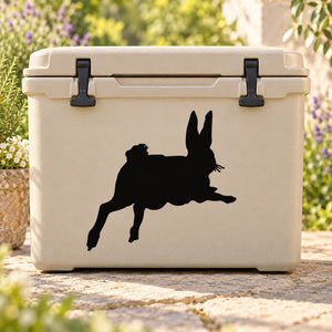 Hopping rabbit wall decal in black silhouette on a beige cooler