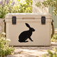 Sitting rabbit silhouette decal, black design on light beige surface