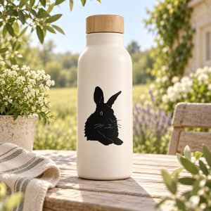 White water bottle with black resting rabbit decal and bamboo lid
