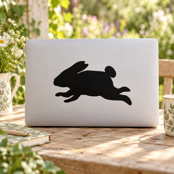 Leaping rabbit decal sticker with black jumping rabbit silhouette on light laptop lid