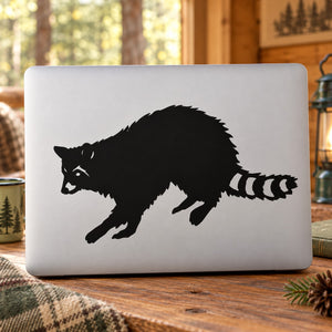 Raccoon reaching decal featuring a black raccoon with outstretched paw