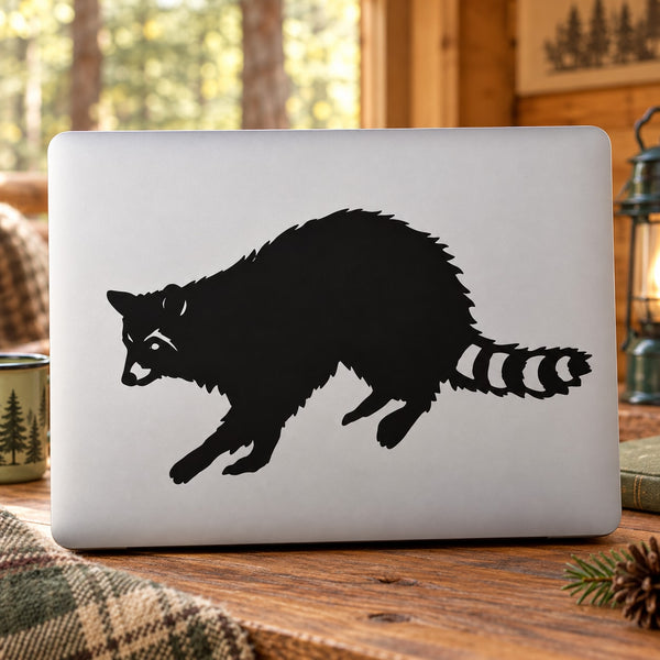 Raccoon reaching decal featuring a black raccoon with outstretched paw