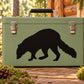Raccoon sniffing decal with black silhouette on olive green surface