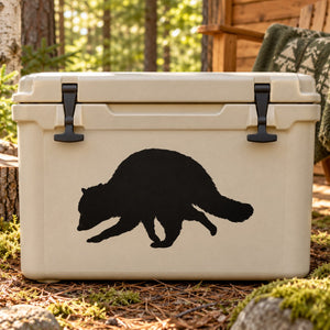 Raccoon scurrying decal: black raccoon design on light beige surface.
