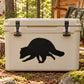 Raccoon scurrying decal: black raccoon design on light beige surface.