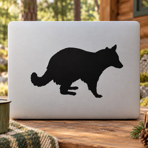 Raccoon observing wall decal with black raccoon silhouette on light gray background