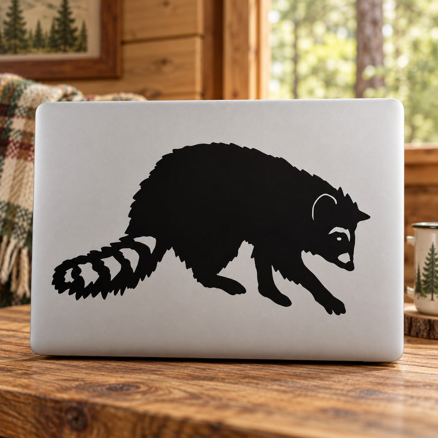Black raccoon animal decal on white laptop lid