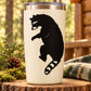 White tumbler with black climbing raccoon decal, looking over