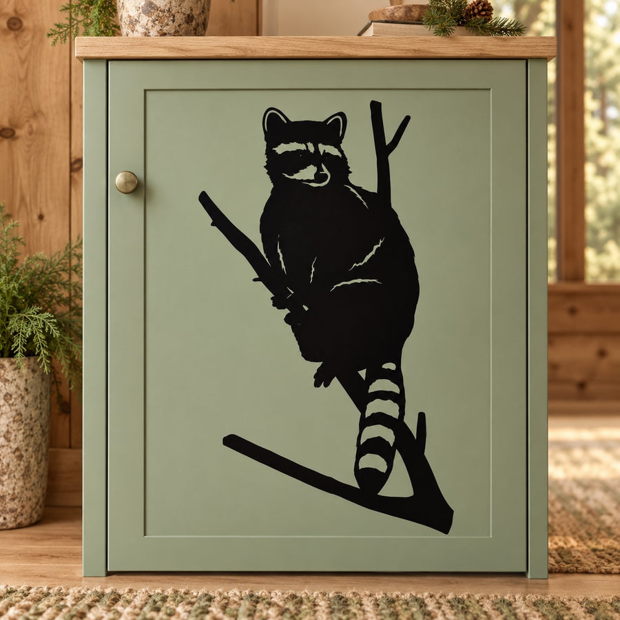 Black raccoon silhouette decal with raccoon perched on a diagonal branch