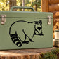 Raccoon grooming decal in black, illustrated raccoon head and body on green surface