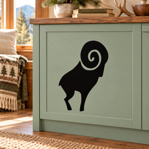 Black ram horn decal with simple swirl graphic on a light cabinet panel