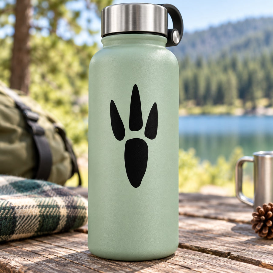 Narrow critter paw print decal with black paw print on mint bottle