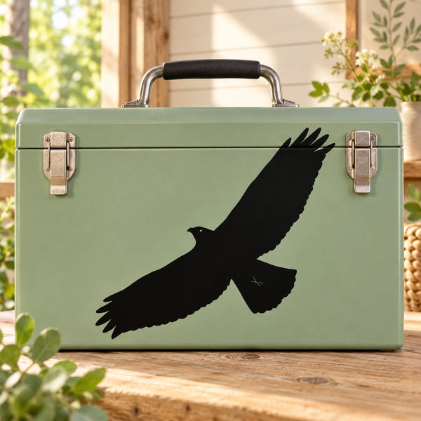 Black flying bird decal on light green suitcase