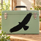 Black flying bird decal on light green suitcase