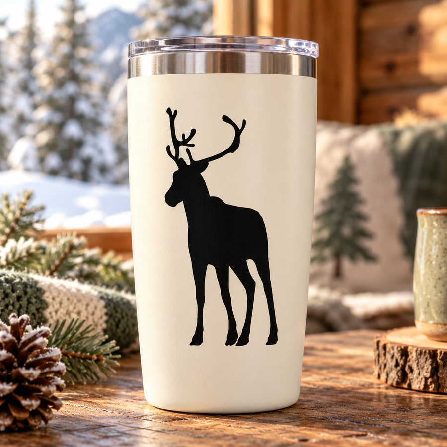 Standing reindeer silhouette decal on cream tumbler with silver rim