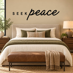 Wall decal with black “SEEK” and “peace” script lettering