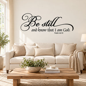 Black cursive wall decal: 'Be still and know that I am God' (Psalm 46:10).
