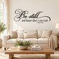 Black cursive wall decal: 'Be still and know that I am God' (Psalm 46:10).