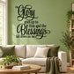 Wall decal with black cursive quote: "The Glory goes up to Him" and "blessings fall down on me"
