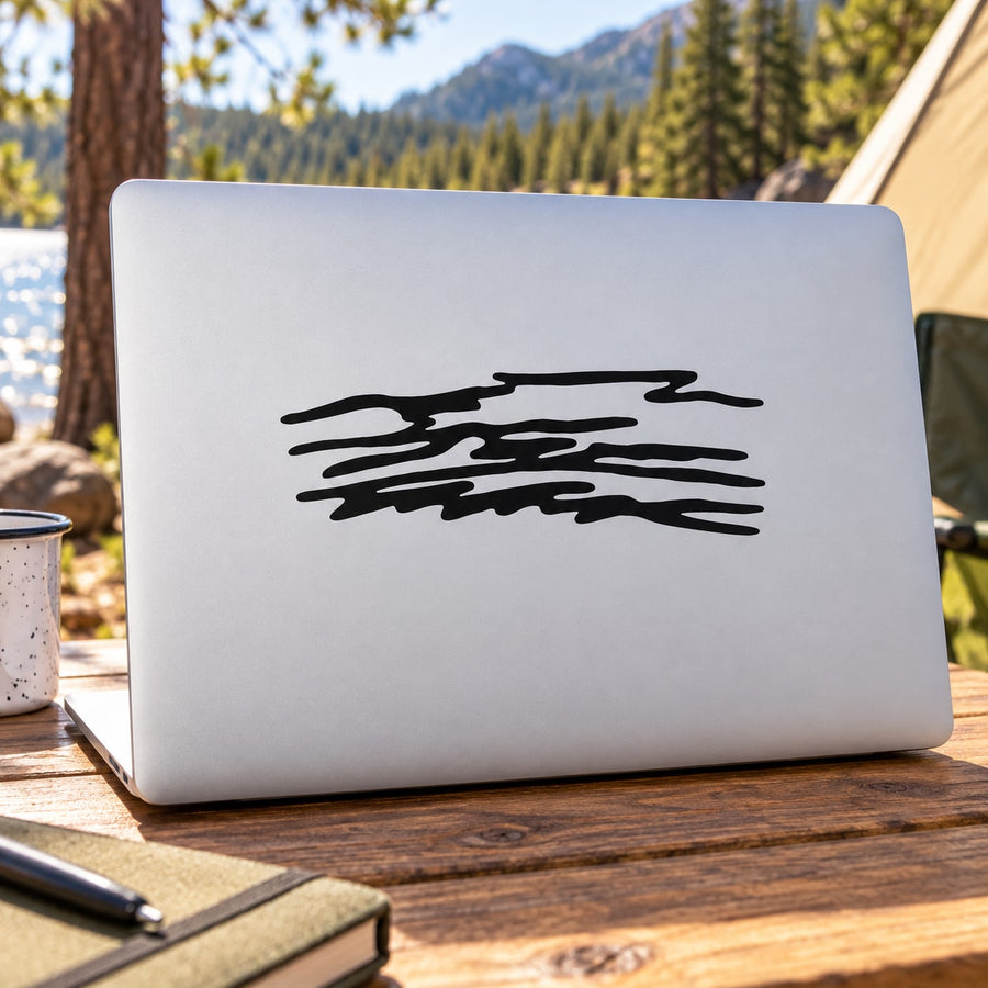 Black ribbon cloud decal sticker on a light rectangular laptop lid