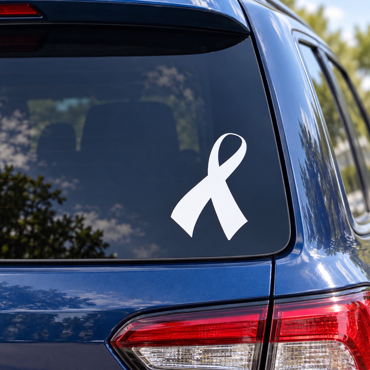 White awareness ribbon decal with curved rightward tail on a car window