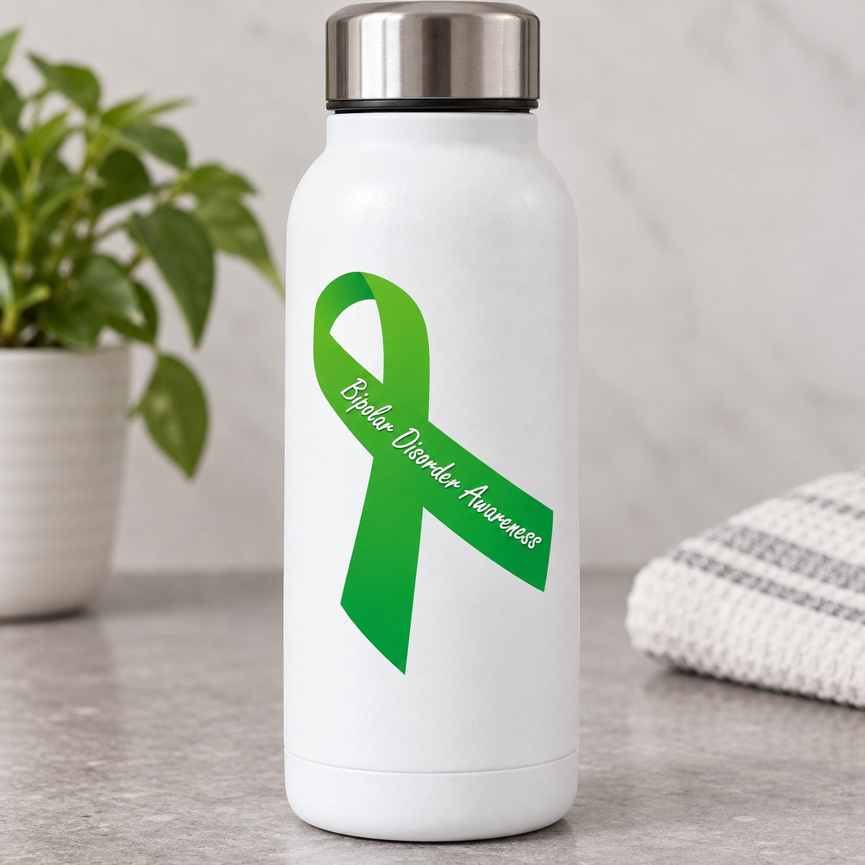 Green bipolar disorder awareness ribbon vinyl sticker on white water bottle