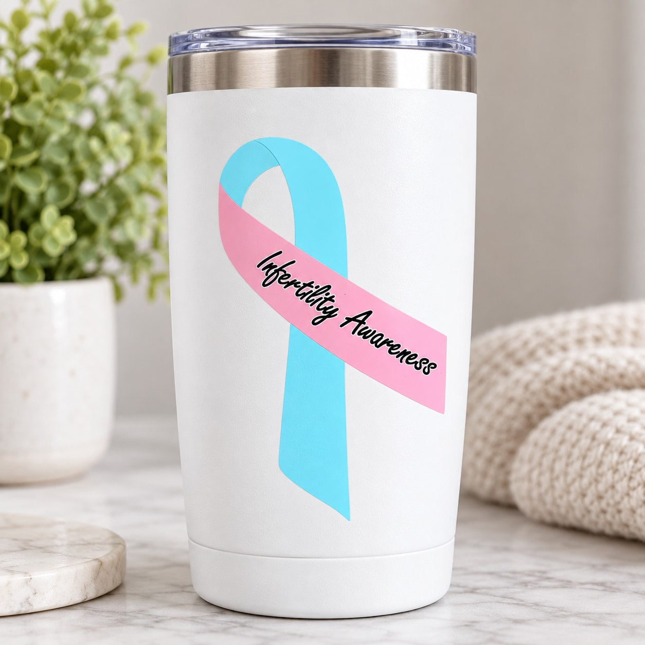 White tumbler with infertility awareness ribbon vinyl sticker in blue and pink