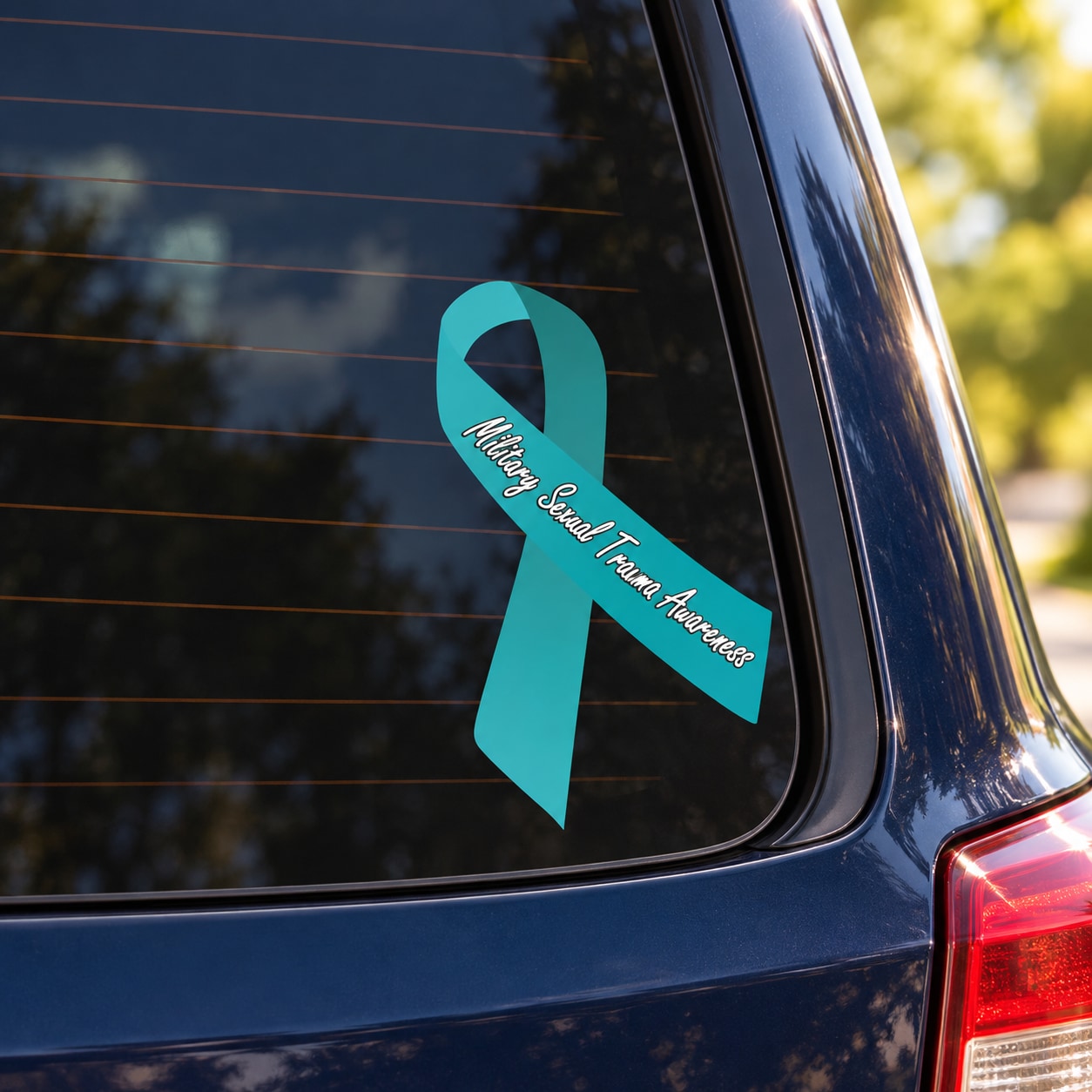 Teal awareness ribbon vinyl sticker with white script text, diagonal on glass