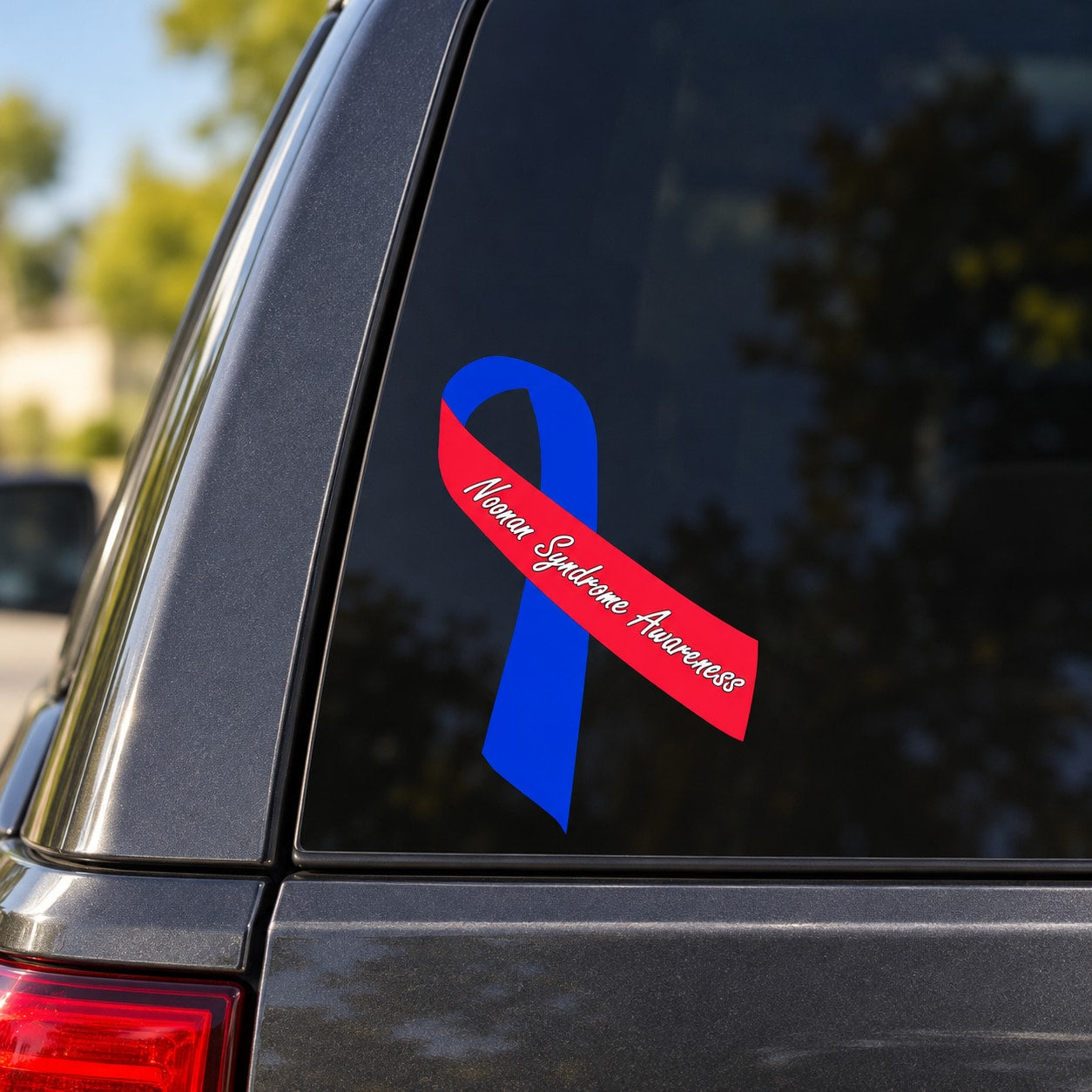 Vinyl awareness ribbon sticker with blue ribbon and red diagonal banner, white cursive text