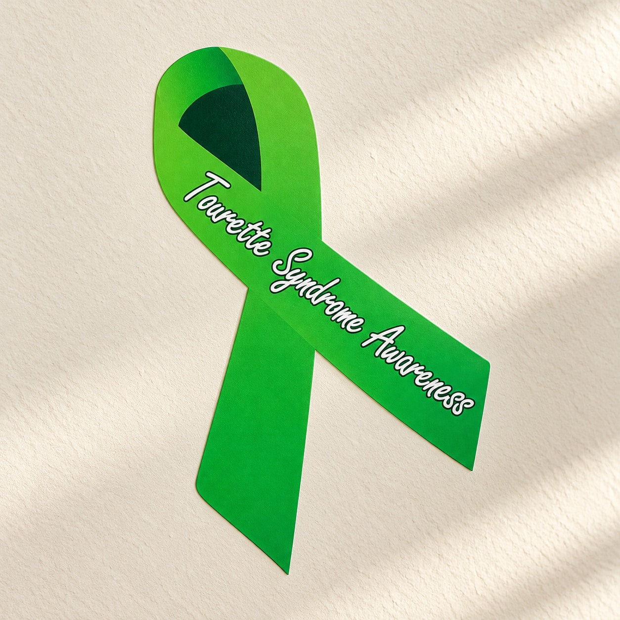 Green Tourette awareness ribbon vinyl sticker with black triangle and white lettering.