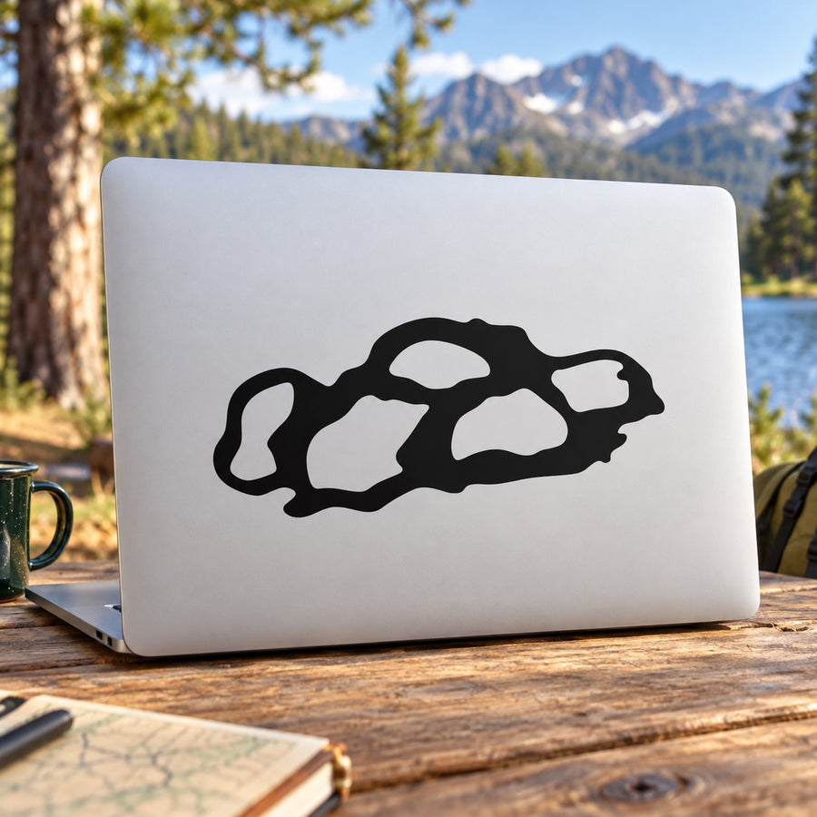 Rock decal sticker with bold black rock outline on a light surface