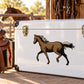 Running horse sticker with brown and black silhouette on a white surface