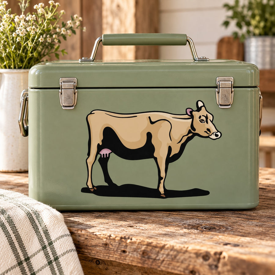 Green suitcase with standing cow sticker featuring udders and black legs