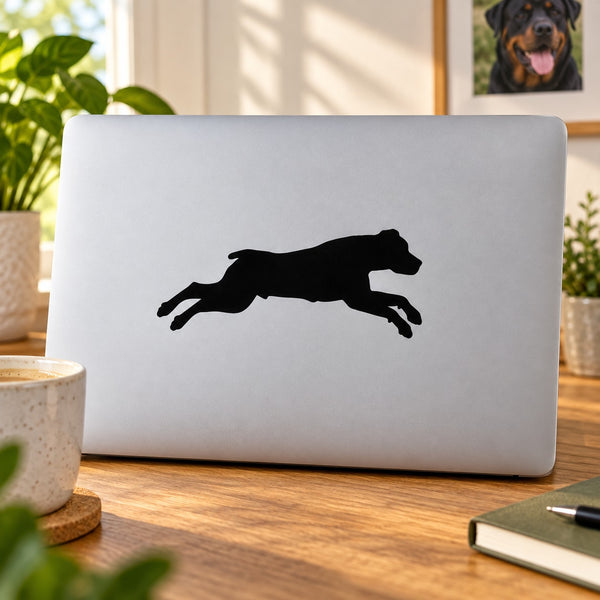 Diving Rottweiler decal sticker with black dog silhouette on light gray laptop lid