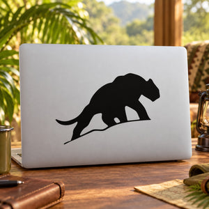 Black saber-tooth tiger silhouette decal on white laptop lid