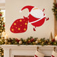 Christmas sticker: red Santa pulling a gift sack with gold star accents