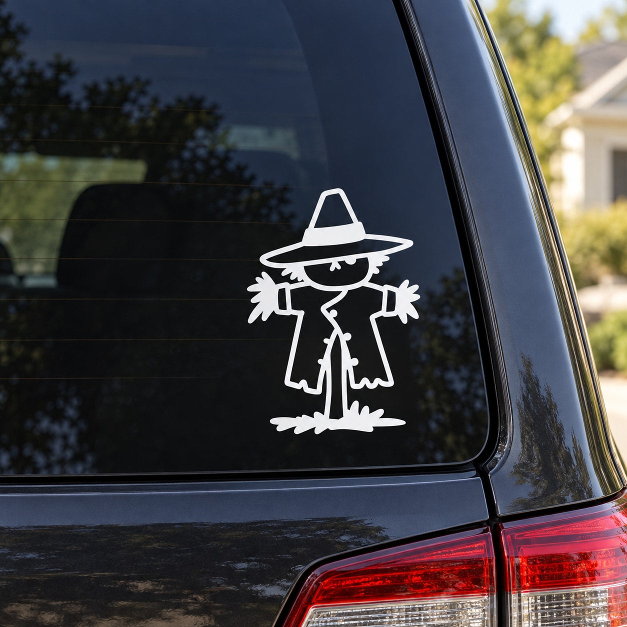 Black-and-white scarecrow vinyl decal on a car window